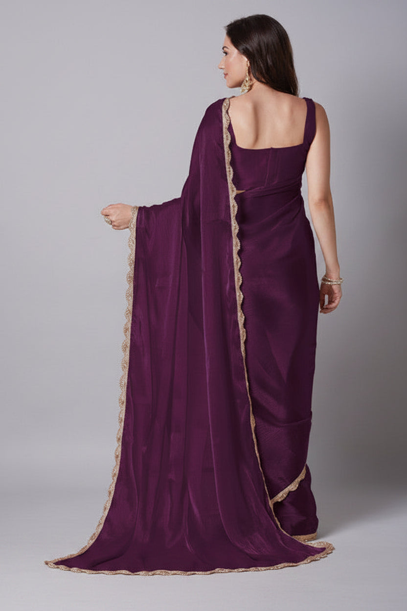 Woman wearing a purple saree with a beige background