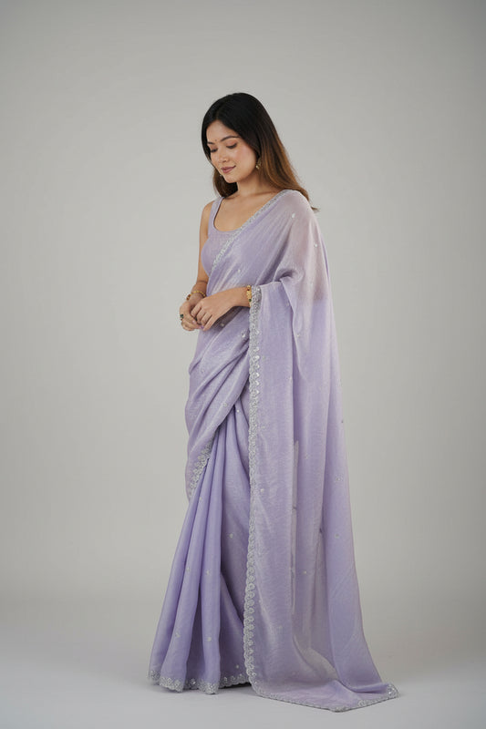 Woman wearing a lavender saree with a white background
