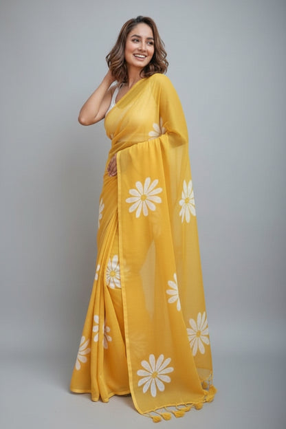 Woman wearing a yellow saree with white floral patterns on a white background