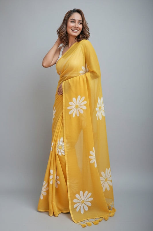 Woman wearing a yellow saree with white floral patterns on a white background