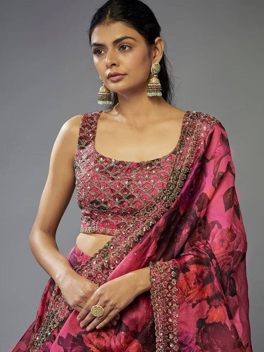 Woman wearing a pink traditional outfit with intricate designs on a gray background 